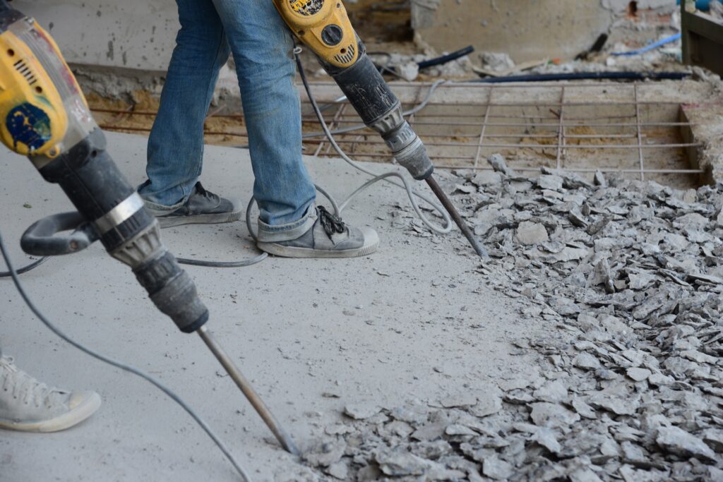 Photo of workers removing concrete flooring